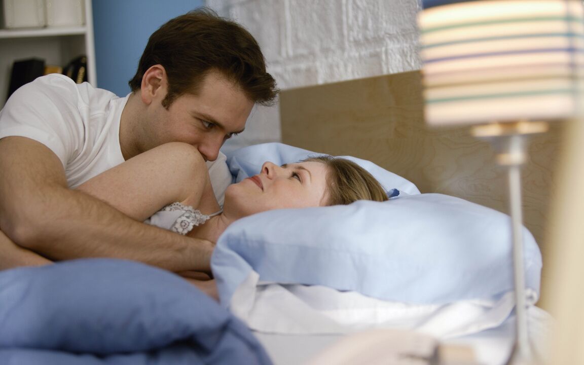 a woman in bed with a man with genital enlargement
